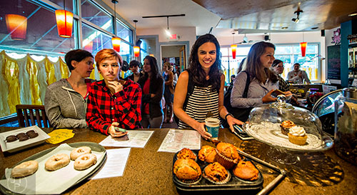 Customers stand in line, passing plates of donuts and muffins, as they wait for their coffee during the Netflix Gilmore Girls Luke's Diner Takeover on Wednesday morning.