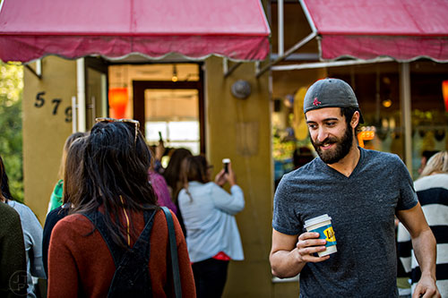 With a Luke's coffee cup in hand, a customer leaves JavaVino in Atlanta after grabbing a cup of joe during the Netflix Gilmore Girls Luke's Diner Takeover on Wednesday morning.