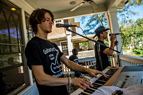 Daniel Hearn, Brandon Rawls and Collin Killtrick perform off of Olympic Pl. during the annual Oakhurst Porchfest on Saturday.
