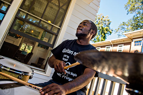 Brandon Rawls performs off of Olympic Pl. during the annual Oakhurst Porchfest on Saturday.