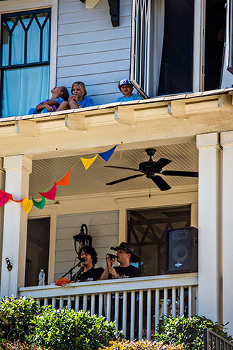 Children sit on the roof above Daniel Hearn and Collin Killtrick as they perform during the annual Oakhurst Porchfest on Saturday.
