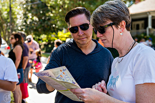 Leigh Layton (right) and her husband Todd check out the map during the annual Oakhurst Porchfest on Saturday.