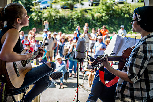 The 3 Percent's Kate Joy (left) and Ryan Murphy perform off of Mead Rd. during the annual Oakhurst PorchFest on Saturday.