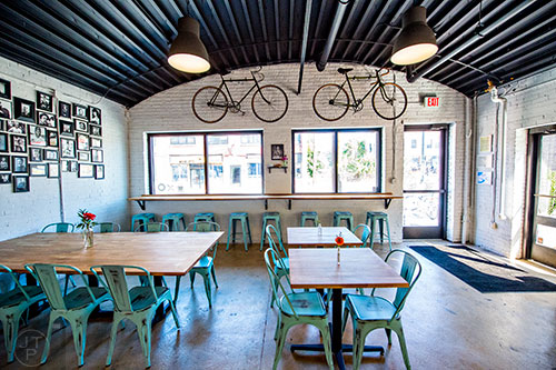 Bicycles hang on the wall above the long counter at Cafe + Velo in Atlanta.