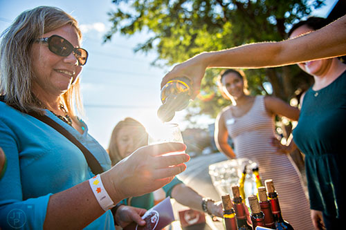 Heather Borowski holds her glass as wine is poured during the Kirkwood Wine Stroll on Friday.