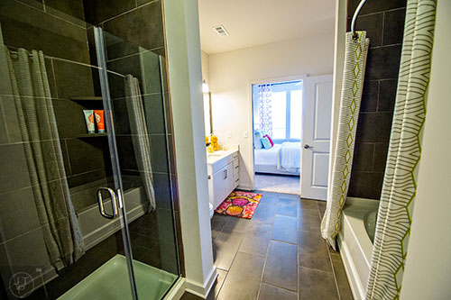 The master bath inside the one bedroom model unit has both a stand up shower and a garden soaking tub at Station R in Atlanta.