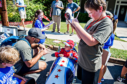 William Roach (right) writes down his remarks as he judges Anthony Amelio's car before the start of the 6th annual Madison Ave. Soapbox Derby in Oakhurst on Saturday.