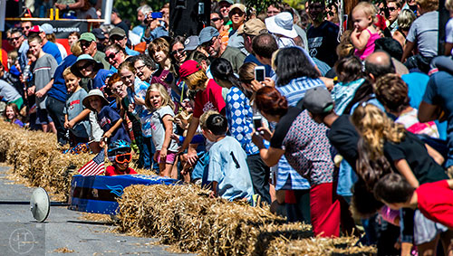 Sai Kakarala crashes during the 6th annual Madison Ave. Soapbox Derby in Oakhurst on Saturday.