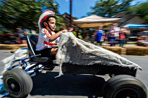 Pierce Haddad races down the street during the 6th annual Madison Ave. Soapbox Derby in Oakhurst on Saturday.