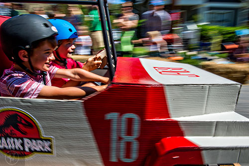 Will Zygmont and is brother Maxwell race down the street in a Jurassic Park jeep during the 6th annual Madison Ave. Soapbox Derby in Oakhurst on Saturday.