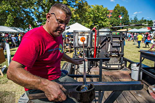 Matt Janke plies his craft as he blows glass in a demonstration during the Atlanta Maker Faire in Decatur on Saturday.