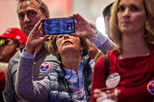 Beth Lippa takes photos of poll results as they come in during the GOP Election Party at the Tech Center Doubletree Hotel in Denver on Tuesday, November 8, 2016.