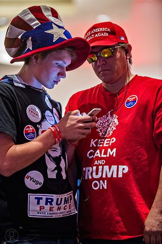A.J. McMillen (center) talks to his father Seth (right) as they watch poll results come in during the GOP Election Party at the Tech Center Doubletree Hotel in Denver on Tuesday, November 8, 2016.