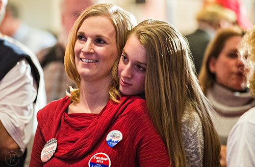 Caitlyn Buchanan (right) holds onto her mother Amy as they watch Fox News coverage during the GOP Election Party at the Tech Center Doubletree Hotel in Denver on Tuesday, November 8, 2016.