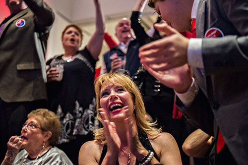 Dede Laugesen (center) claps and cheers as states are called Republican during the GOP Election Party at the Tech Center Doubletree Hotel in Denver on Tuesday, November 8, 2016.