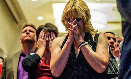 Dede Laugesen (center) says a little prayer during the GOP Election Party at the Tech Center Doubletree Hotel in Denver on Tuesday, November 8, 2016.